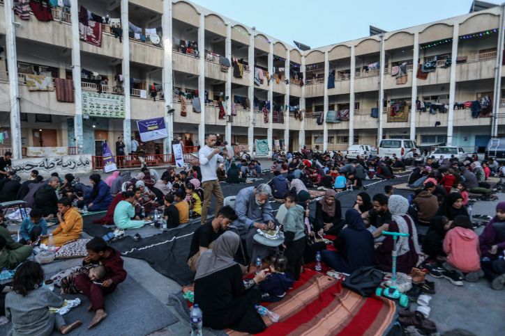 UN Expert Warns Of Wartime Mental Health Risks For Gazans Displaced Palestinians eat iftar at Taha Hussein School during the Muslim