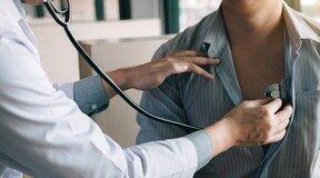 Fitness: Eight essential ways to improve heart health A doctor holds a stethoscope to a patient's chest.