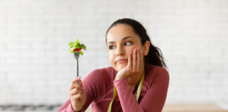 Psychologist Reveals How to Train Your Brain to Eat a Healthier Diet Woman eating salad