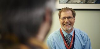 VA psychiatrists work to improve the mental health of Veterans A VA psychiatrist smiles in conversation with a Veteran patient.