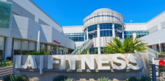 DOJ sues LA Fitness for alleged disability discrimination LA Fitness sign outside a gym in a commercial district of LA.