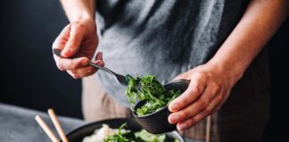 Fibre: The surprisingly simple supernutrient with far-reaching health benefits Close-up of woman eating omega 3 rich salad. Female having healthy salad consist of chopped salmon, spinach, brussels sprouts, avocado, soybeans, wakame and chia seeds in a bowl.