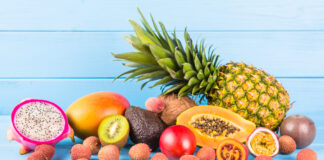 Highest Protein Fruit Revealed by Nutritionists Fresh ripe fruit on blue wooden background