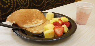 Nutrition’s Lindsay Malone says skipping breakfast might work for some people, depending on their bodies A plate with pancakes and fruit next to a cup with a smoothie sitting on table at Late Night Breakfast