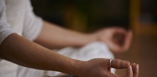 2025: Relaxation techniques may help lower high blood pressure | Centre for Academic Primary Care Person sitting in lotus position (hands on knees)