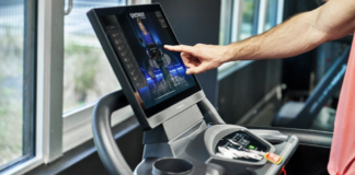 How Echelon is Reshaping Fitness With AI closeup of man touching Echelon treadmill screen