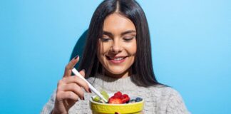 I Overlooked These 12 Foods Until I Learned How Healthy They Are Woman easting bowl with fruits