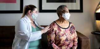 Mental health recovery from long COVID takes three times longer than physical healing, study finds Image of clinician checking patient's lungs with stethoscope