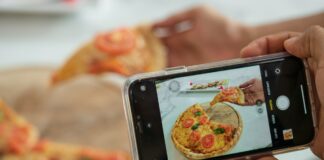 Clean eating trends on Instagram may subtly harm body satisfaction Person taking photo of pizza with smartphone