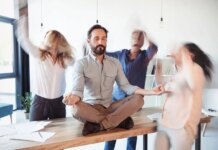 Elevating Corporate Culture Through Stress Relief and Energy Elevating corporate culture - sitting on table and meditating