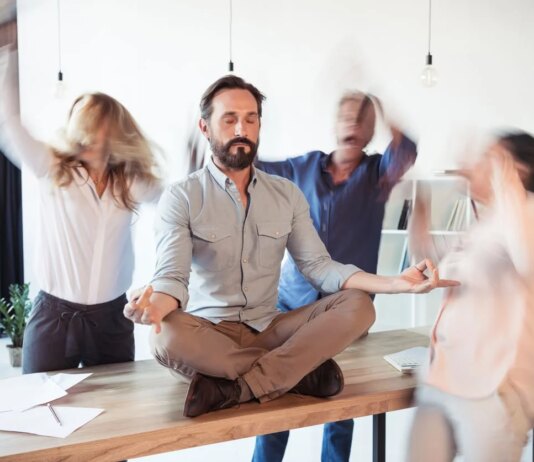 Elevating Corporate Culture Through Stress Relief and Energy Elevating corporate culture - sitting on table and meditating