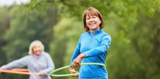Regular aerobic exercise slows a key marker of brain aging in midlife Senior women are doing exercise with hoop for fitness and coordination