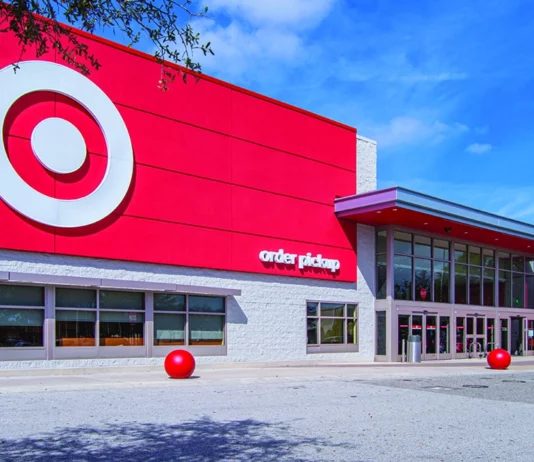 Target Is Adding More Wellness Products as Big Retail Shifts Its Focus Exterior of a Target store with a bright red facade, large bullseye logo and an order pickup entrance under a blue sky.
