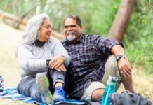 6 lifestyle changes to improve heart health and lower your risk of heart disease | Cultivating Health A senior couple enjoying a picnic on a blanket in the woods.