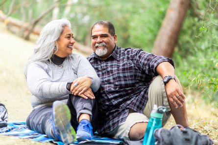 6 lifestyle changes to improve heart health and lower your risk of heart disease | Cultivating Health A senior couple enjoying a picnic on a blanket in the woods.