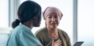 The Gene‑Therapy Breakthrough Story You'll Be Mad You Ignored at These Prices A medical professional talks to a patient.