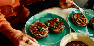 Oura Data Reveals Global Food Trends By Location, Age, and Gender Person wearing Oura Ring eating an open-faced bagel