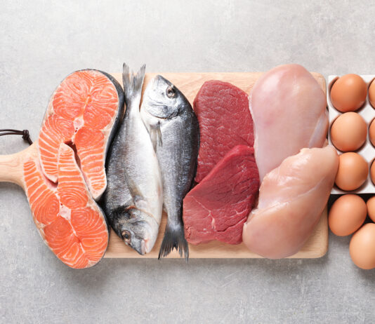 Boy Kibble Be Gone: April Davis Talks Latest TikTok Diet Trends for Reporting Texas | Elson S. Floyd College of Medicine News A wooden cutting board displays a variety of protein-rich foods, including salmon fillets, two whole fish, raw red meat, and raw chicken breasts and a dozen brown eggs.
