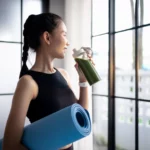 Gen Z & Millennials Are Driving the High-Protein Diet Trend woman drinks a green shake