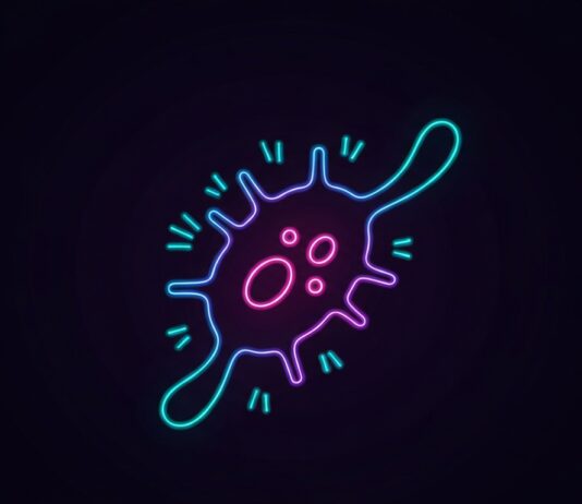 UCLA Researchers Present Advances in Cancer Care at AACR A glowing, neon outline of a microscopic cancer cell against a dark background, conceptually representing the latest breakthroughs in cancer research presented by UCLA scientists.