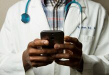 Biggest AI Breakthroughs in Healthcare That Are Transforming Modern Medicine Doctor Holding Cell Phone