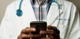 Biggest AI Breakthroughs in Healthcare That Are Transforming Modern Medicine Doctor Holding Cell Phone